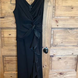 Stunning long black gown / dress. Material is super soft. Super flattering.